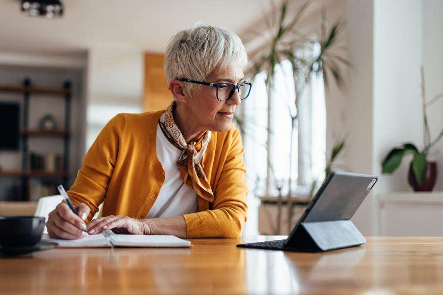 real estate agent working on a tablet at home