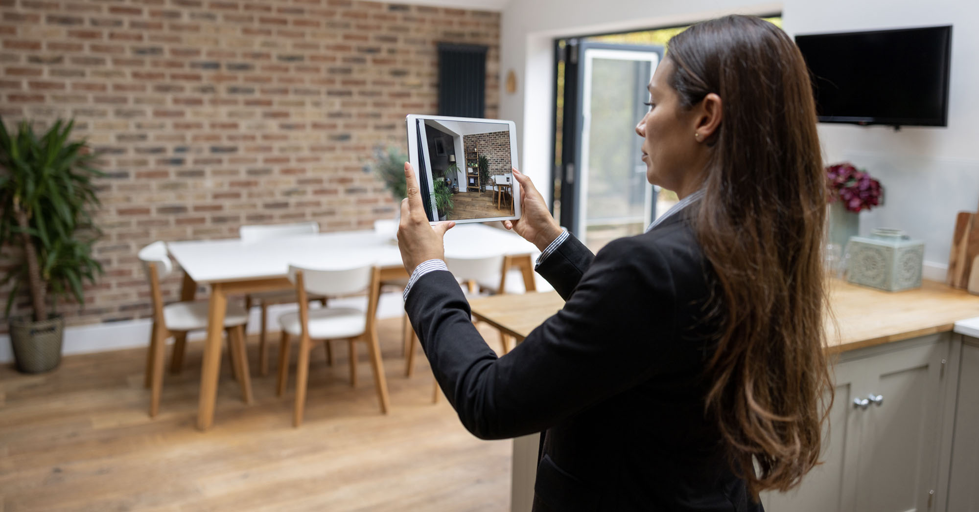 real estate appraiser photographing a property