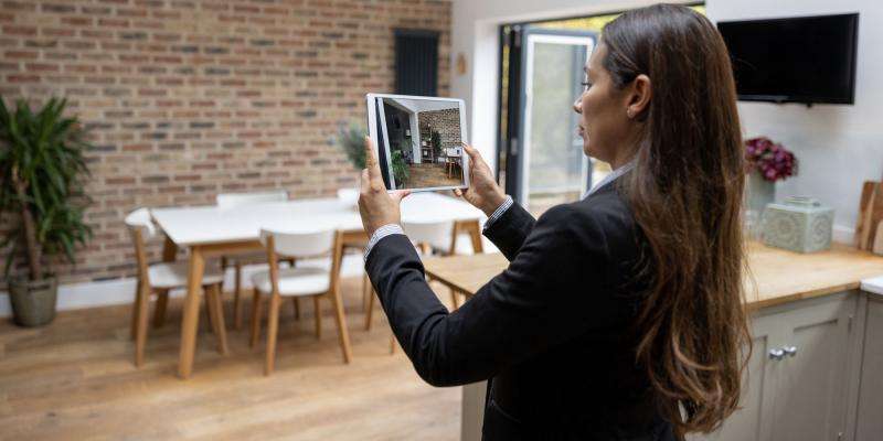 real estate appraiser photographing a property