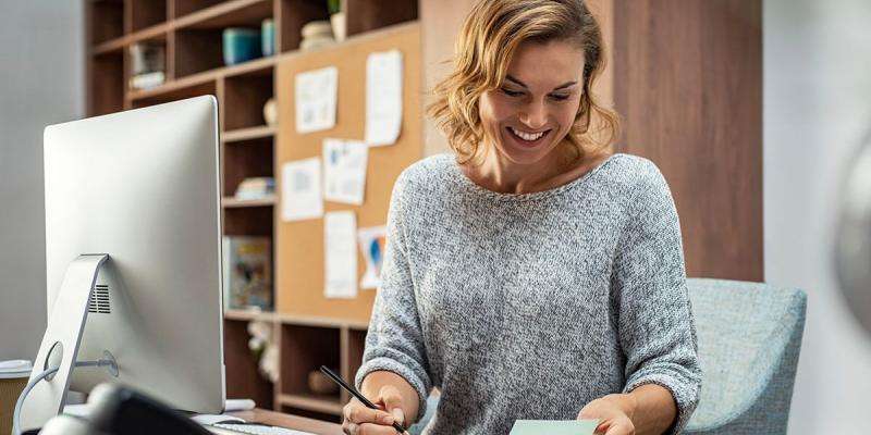 Image of an appraiser studying with a smile on their face